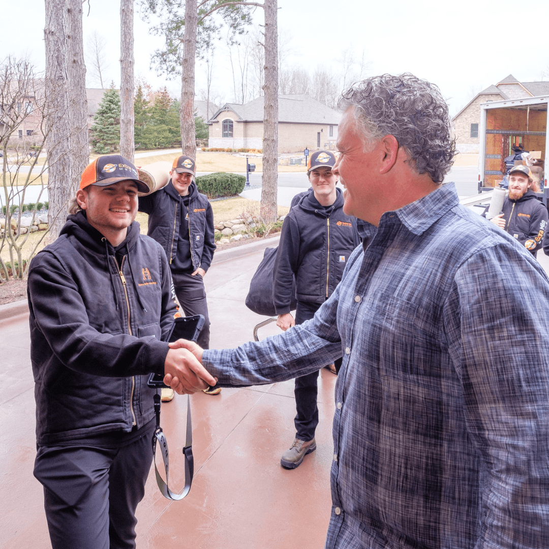 Extra Mile Moving crew member shaking hands with a customer