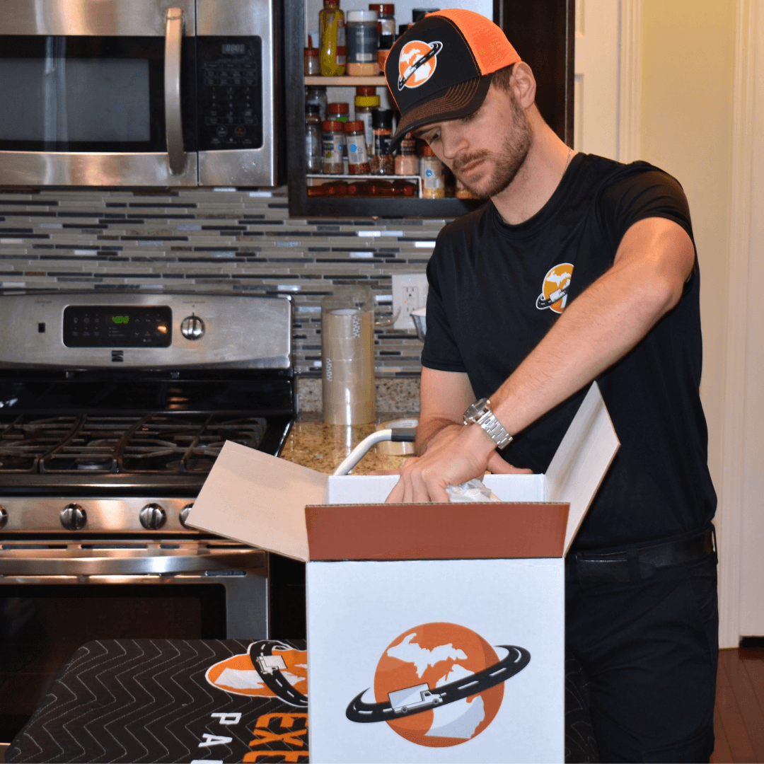 Professional packer carefully wrapping fragile items