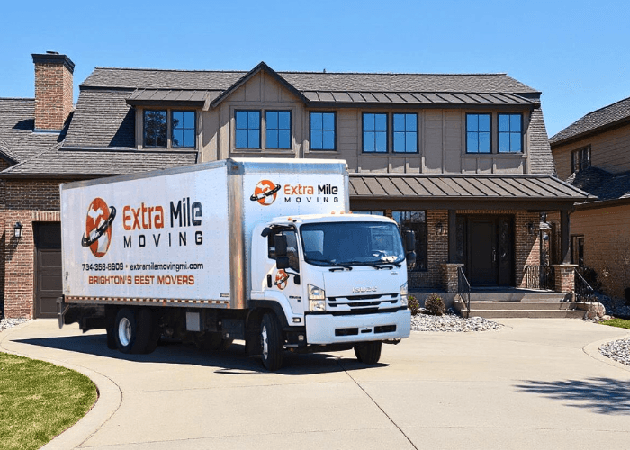 Extra Mile Moving truck parked in front of a customer's new home